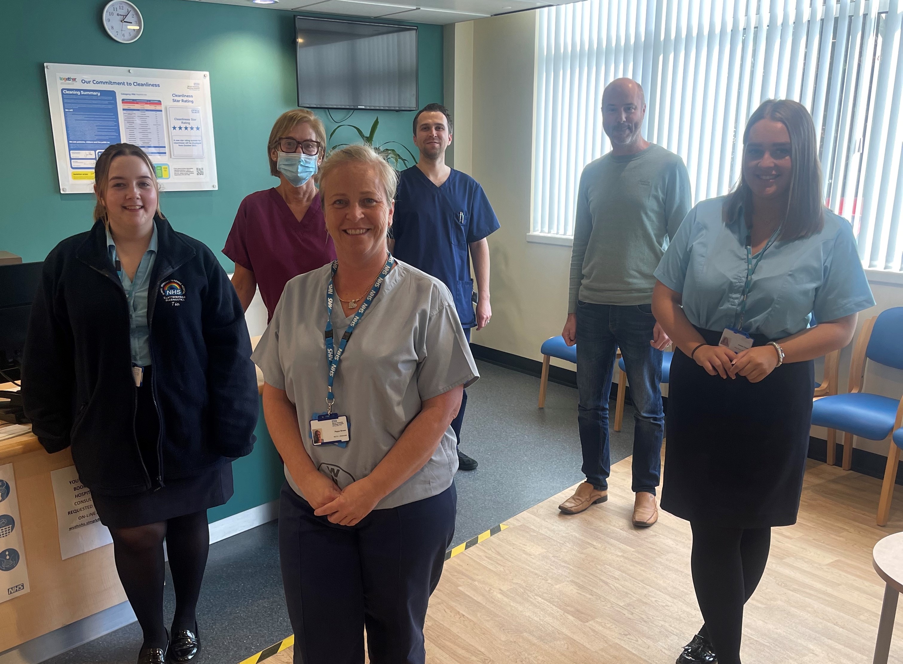 Staff from the Clatterbridge Diagnostics service pictured in their reception area and smiling