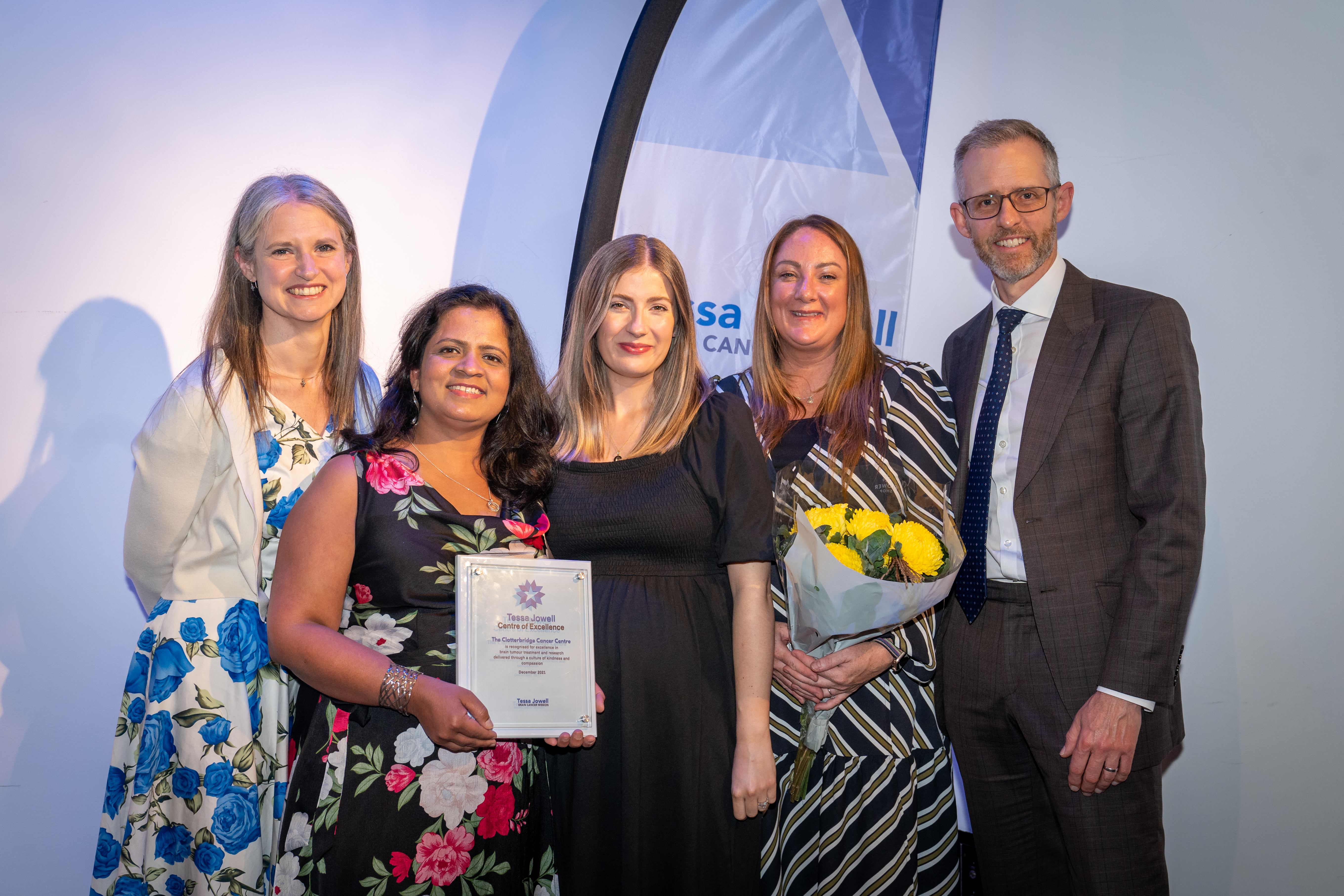 Picture of Dr Shaveta Mehta and Neuro-Oncology CNS Jill Sokratous with colleagues and their Tessa Jowell Centre of Excellence award