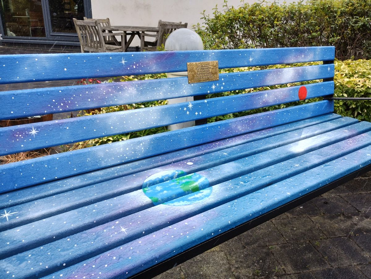 Another of the memorial benches at CCC-Aintree - this one is blue and purple and has a cosmic space theme