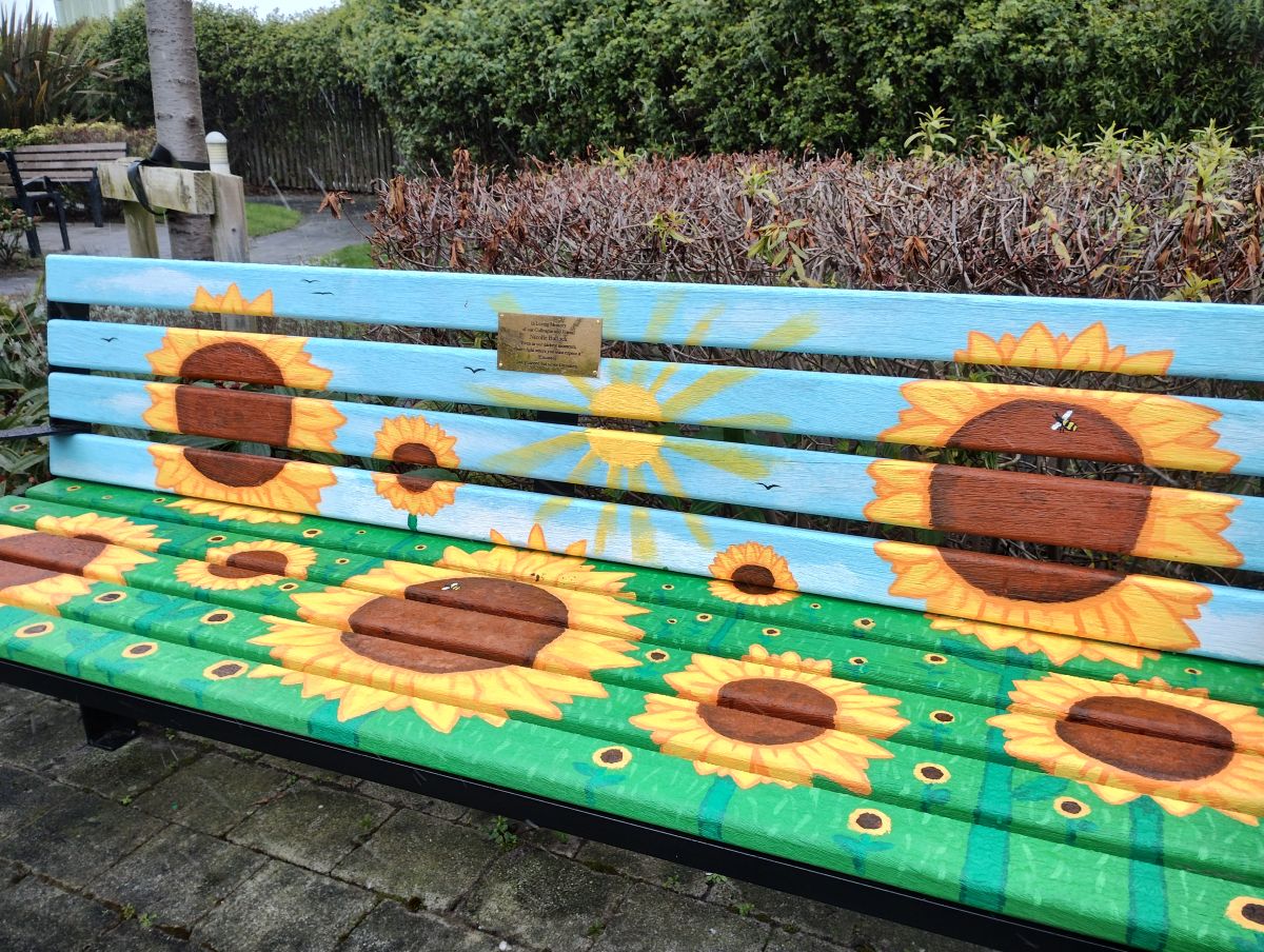 One of the colourful memorial benches - this one features pictures of yellow sunflowers