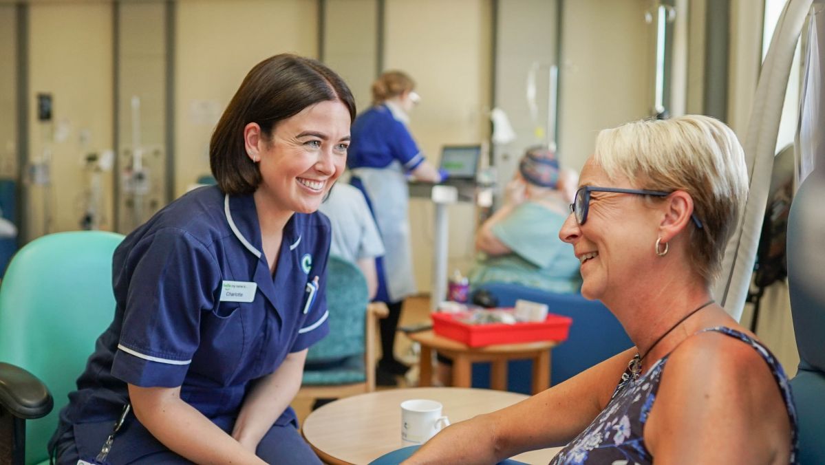 Picture of smiling chemotherapy nurse and a patient who is also smiling