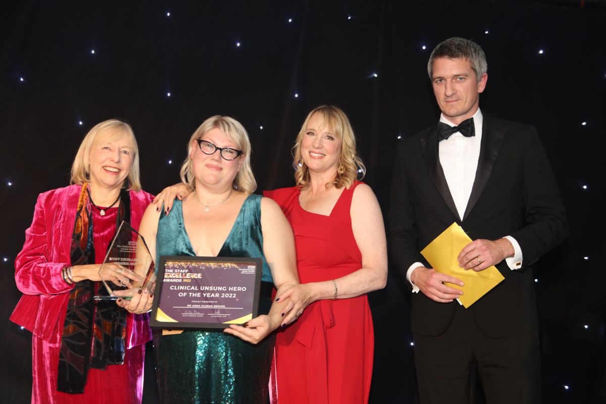 Picture of Dr Anna Olsson-Brown receiving an award last year from the Chair and Chief Executive and the Director of Strategy